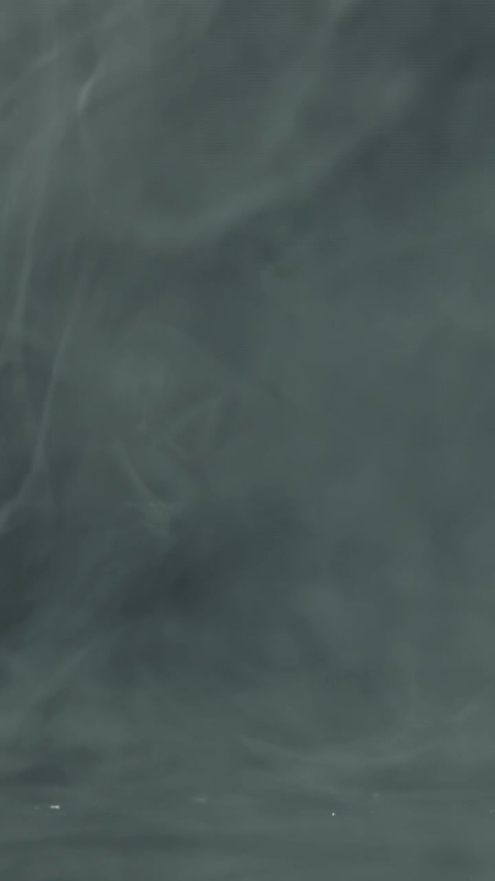 Slow Motion Smoke Swirling on a Dark Background