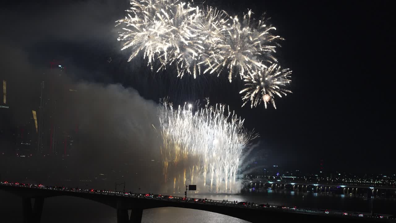 Spectacular Fireworks Display Over City River at Night