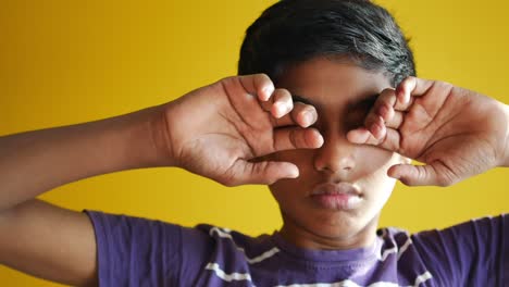 sad teenage boy crying on yellow background ,