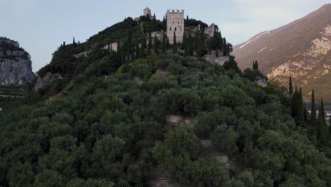 Aerial-View-Arco-Castle-in-Northern-Italy-Tourist-Destination---Boom-Shot