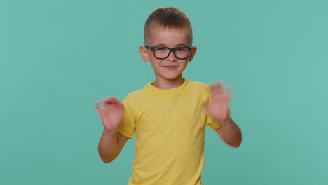 happy toddler children boy smiling friendly at camera and waving hands gesturing hello or goodbye