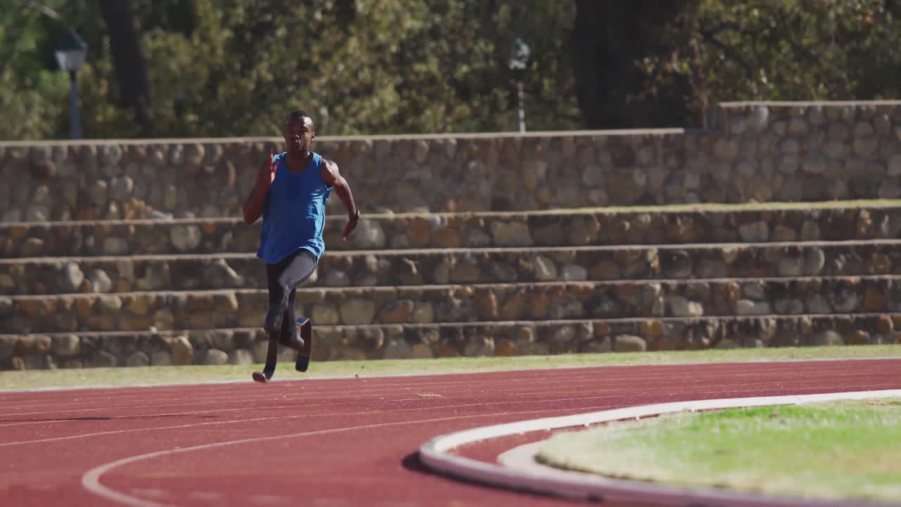 Disabled mixed race man with prosthetic legs running on race track