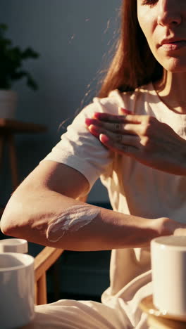 woman applying cream to her arm