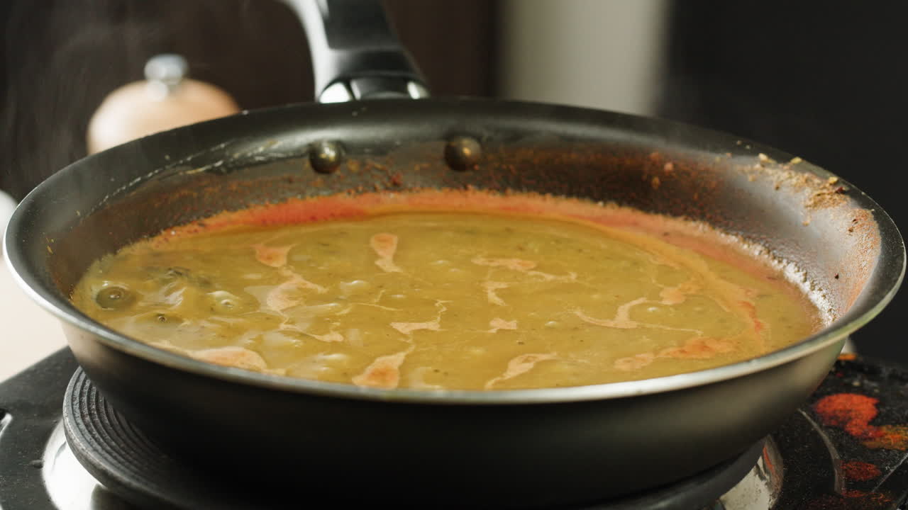 Cooking traditional Indian meal Palak Panir with spinach and cheese close up. Palak paneer is an Indian dish, consisting of paneer in a thick paste made from pureed spinach, Palak paneer is prepared by first boiling and pureeing spinach.