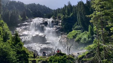 the giant grawa falls in stubai valley in austria with sunny weather and with some people