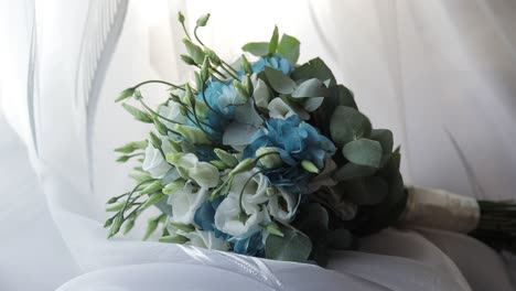 beautiful wedding bouquet lie near window on white curtains