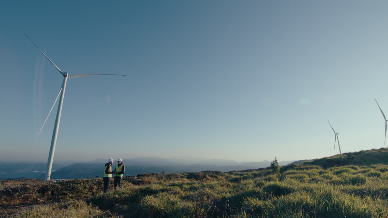 Two Engineers Having Discussion at Wind Farm