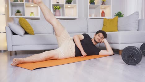 Man-stretching-his-legs-does-sports-at-home.