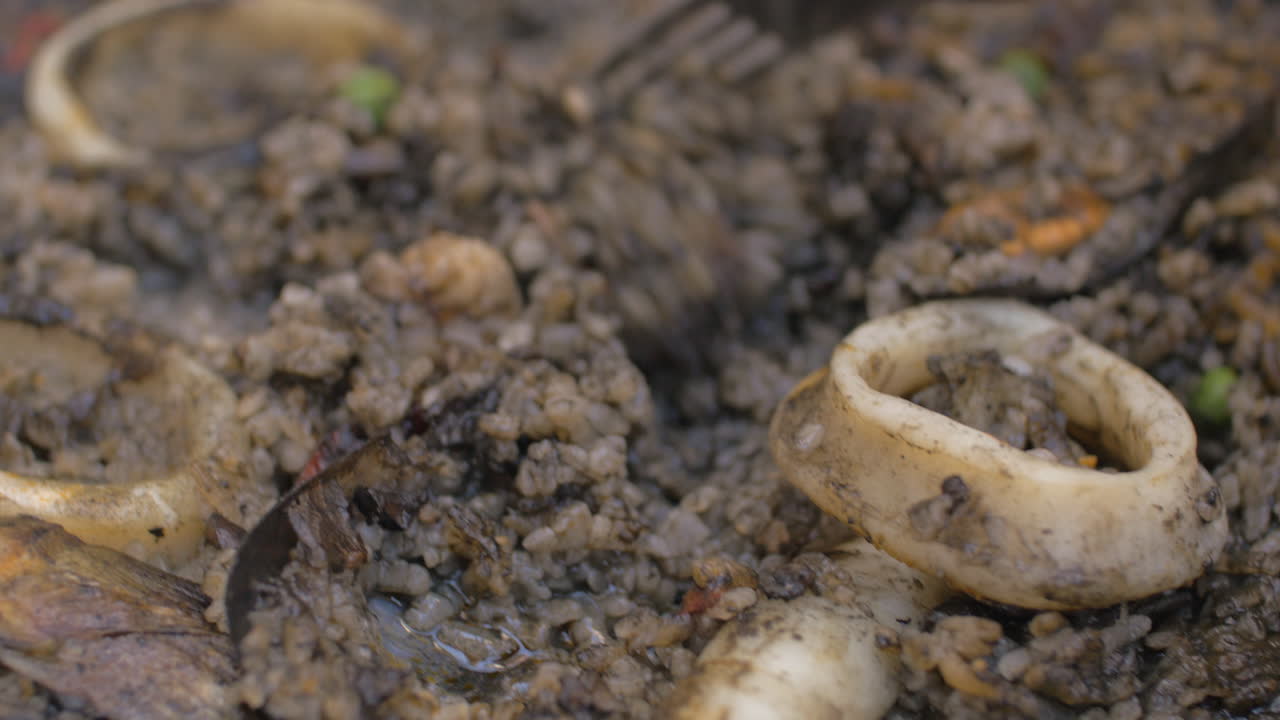 Eating Spanish black paella with seafood