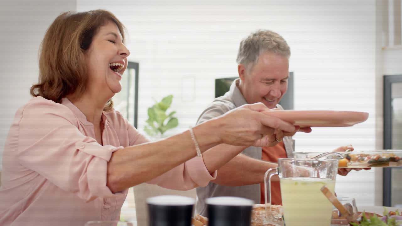 Family passing plates at home table, man offering platter launching animated food labels for meal