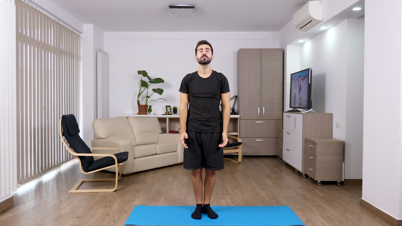 Man doing yoga at home