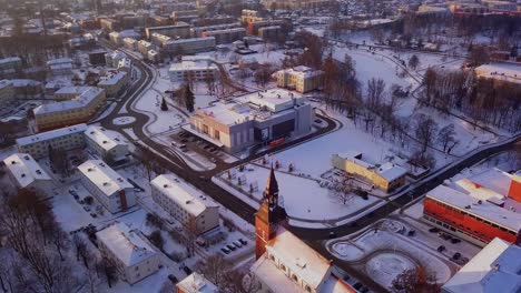 beautiful drone shot flying over the city of valmiera, latvia in winter, with a view of the st