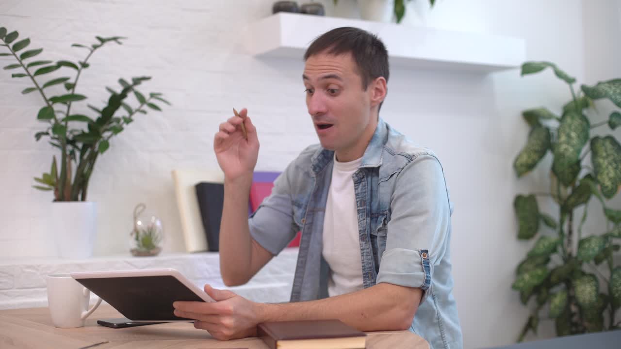 hombre trabajando con la tableta en la mesa en casa, una nueva idea vino al hombre