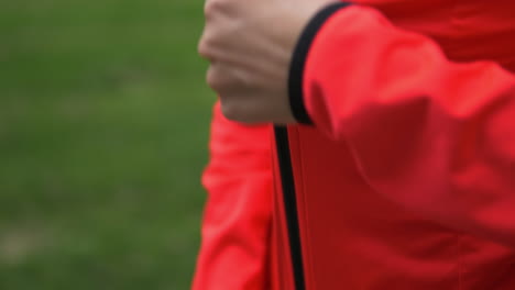 Smiling-Healthy-Active-Woman-Zipping-Up-Bright-Neon-Red-Track-Jacket