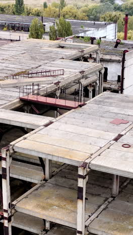 ruined buildings. industrial constructions without windows on abandoned plant. old manufacture. circling view.. vertical video