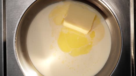 Draufsicht-Auf-Butter,-Die-In-Sahne-Oder-Milch-In-Einer-Pfanne-Schmilzt