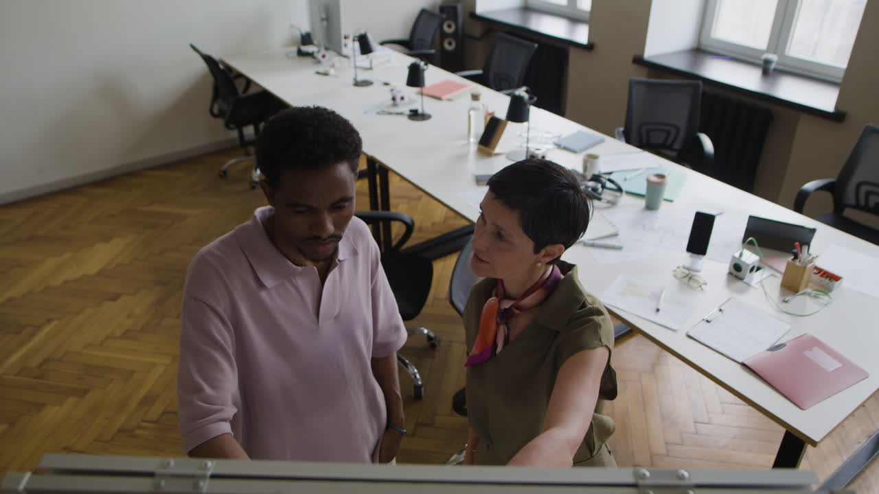Two colleagues collaborating in a modern office