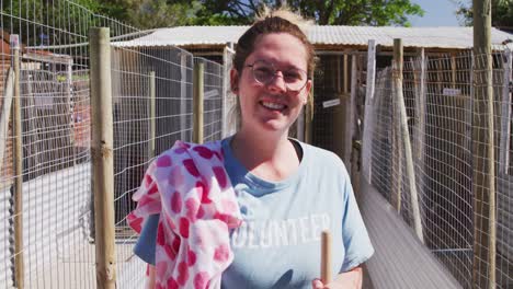 caucasian volunteer woman in a dog shelter