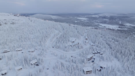 drone shot of cabins and traffic on a fell, gloomy winter day in lapland