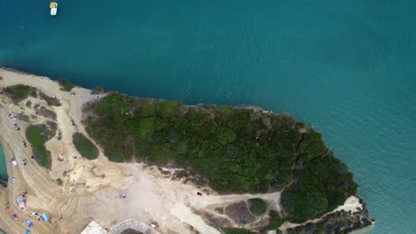 Sail-boat-moored-in-Mediterranean-Sea-coastline-of-Greece-corfu-island-aerial-top-down-view