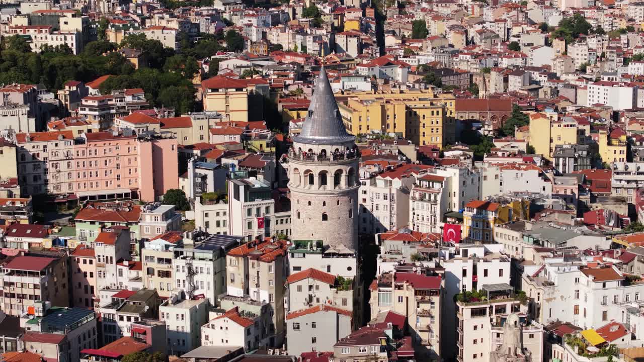 Amazing Orbiting Drone Shot Above the Famous Galata Tower in Istanbul, Turkey, on Bright Summer Day, with Panoramic Views of the City and Bosphorus Strait