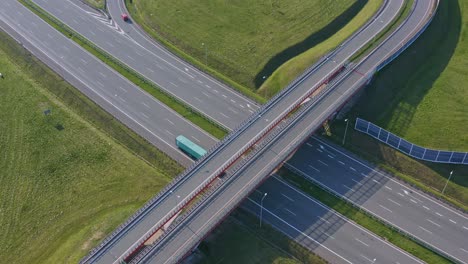 highway overpass with traffic in day, trucks and cars