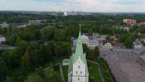 aerial panorama of dobele town center and evangelical lutheran church at summer scenic drone view in golden hour light over dobeles historic center on a warm summer evening peaceful latvian town
