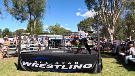 wrestlers competing in an outdoor wrestling ring