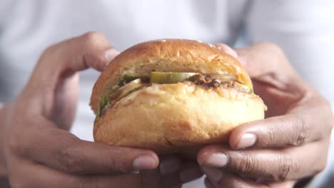 chef holding a delicious burger