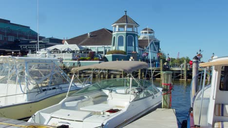 Sunny-day-at-Alexandria-waterfront-with-boats-docked-and-buildings-in-background,-wide-shot