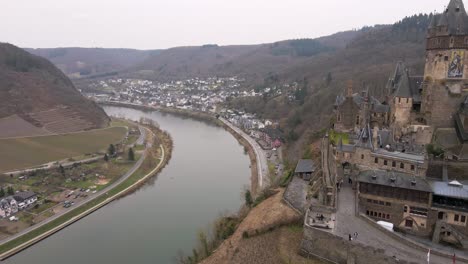 drone flight passes the cochem castle and over the river moselle with a wide view of the city