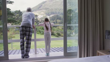 girl with father looking out of the balcony 4k