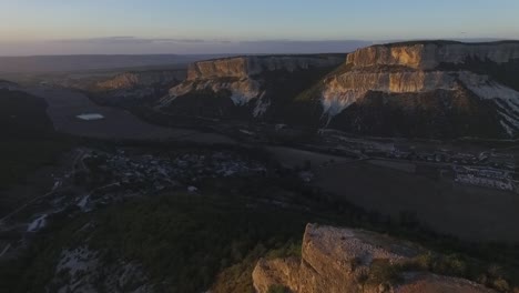 aerial view of a canyon and village at sunrise/sunset