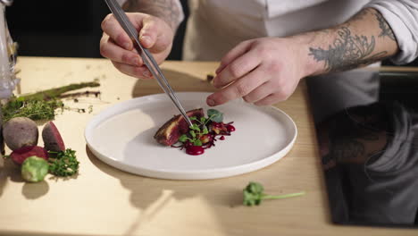 chef plating gourmet duck dish