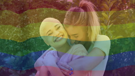 animation of rainbow flag over diverse female couple embracing