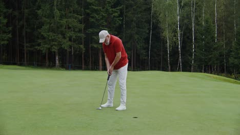 man playing golf on a putting green