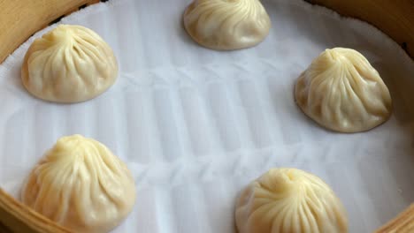 close up circle movement of xiao long bao, streamed pork dumplings chinese food or taiwan food in the restaurant