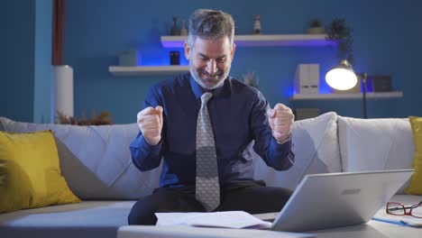 mature businessman receiving good news is surprised and happy at home.