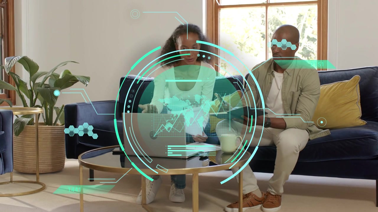 Woman typing on laptop, initiating man flipping papers on sofa, teal HUD highlighting business docs