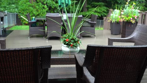 Rain-lightly-pattering-on-a-suburban-deck-during-a-summer-storm-with-highlighted-greens