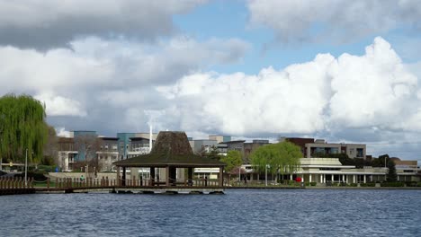 beautiful cloudy day by a neighborhood and a lake