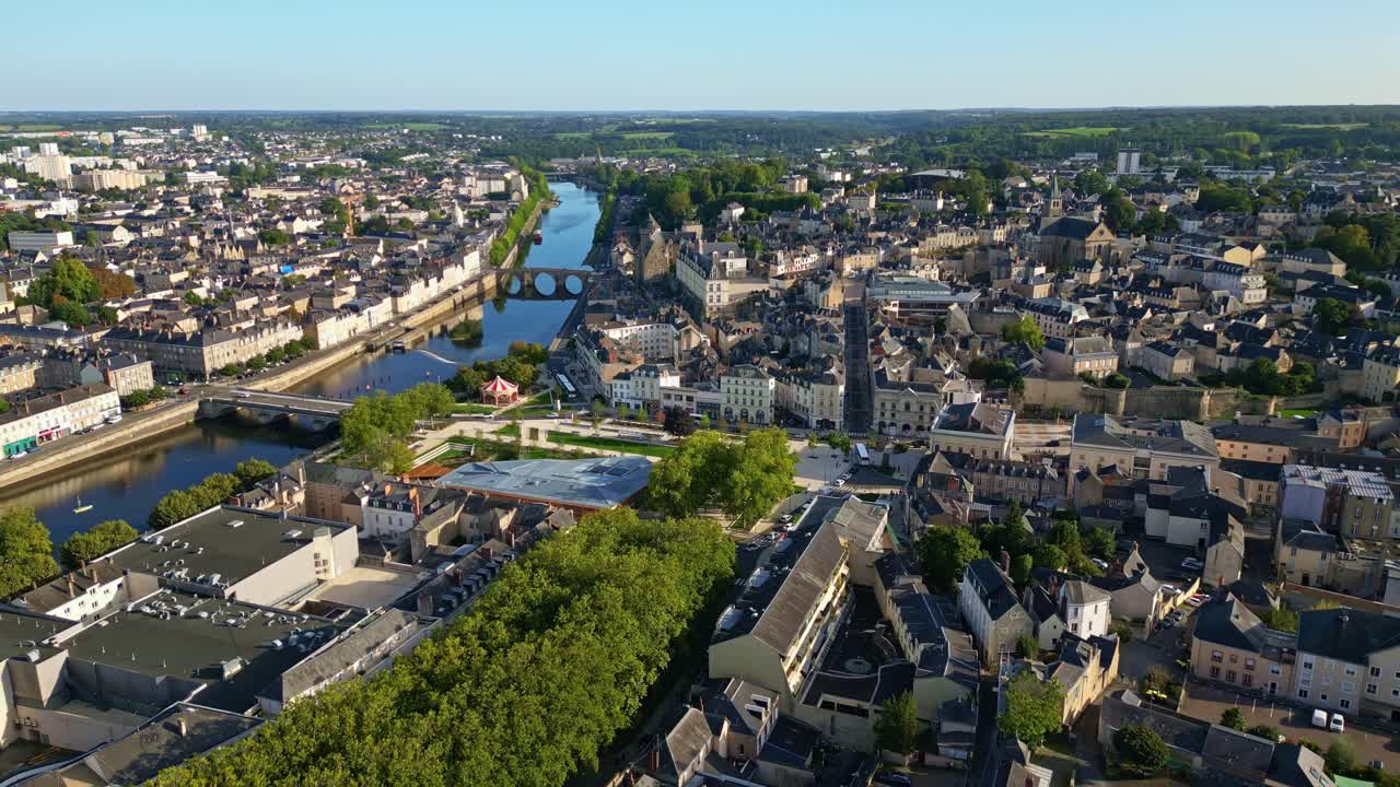 Laval cityscape, Place du 11 Novembre, Château-Neuf, and Mayenne river with bridges, France. Aerial drone backward, tilt-up