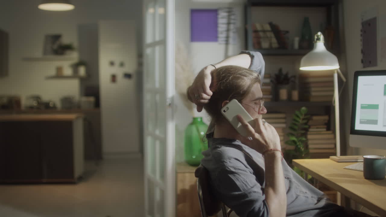 Male Freelancer Talking on Phone in Home Office