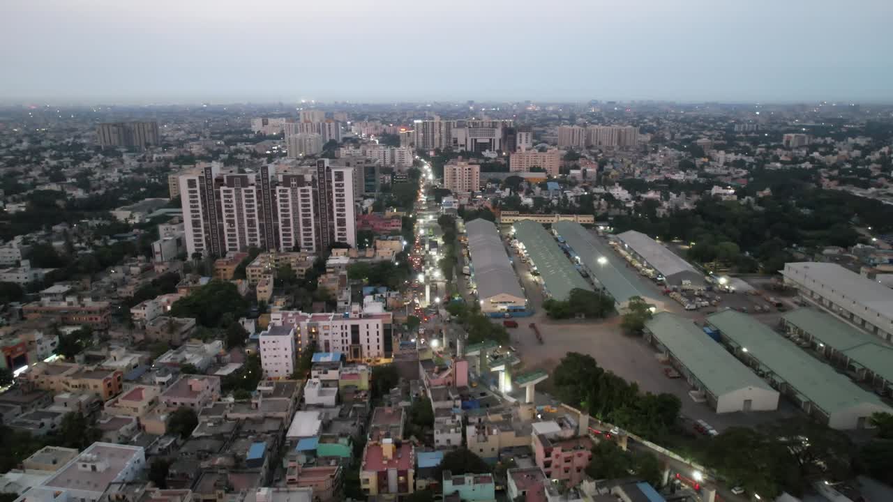 An evening aerial view of Chennai City's crowded neighborhood reveals the city's metro rail construction and warehouses