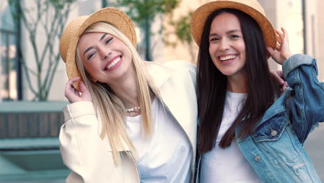 two happy women wearing straw hats