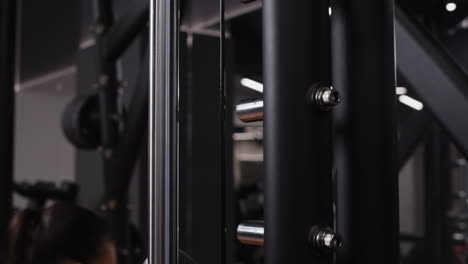 woman working out on a seated row machine in a gym