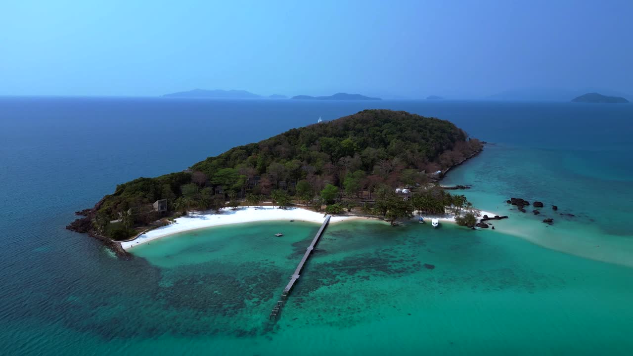 Koh Kham Island with crystal clear turquoise water, white sand beaches and lush tropical vegetation, a popular tourist destination in Thailand. aerial view flight drone shot footage from above