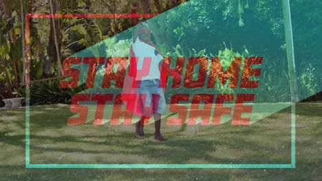 animation of red text stay home stay safe in colourful frame over caucasian boy wearing a cape