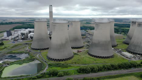 Ratcliffe-on-Soar-nuclear-power-plant-aerial-view-rising-to-reveal-Nottingham-countryside-behind-steaming-cooling-towers