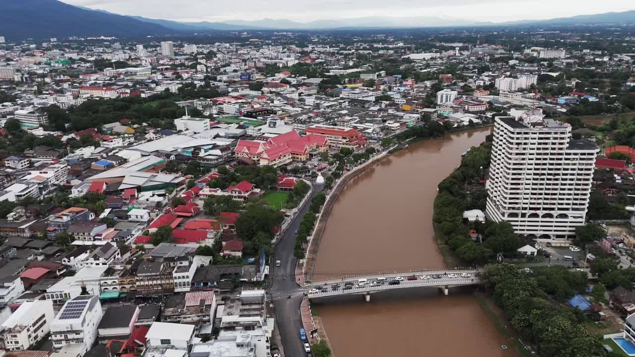 Aerial panoramic of Chiang Mai, Thailand. mountains, cityscape, old town temples, and Ping rivers drone at sunset